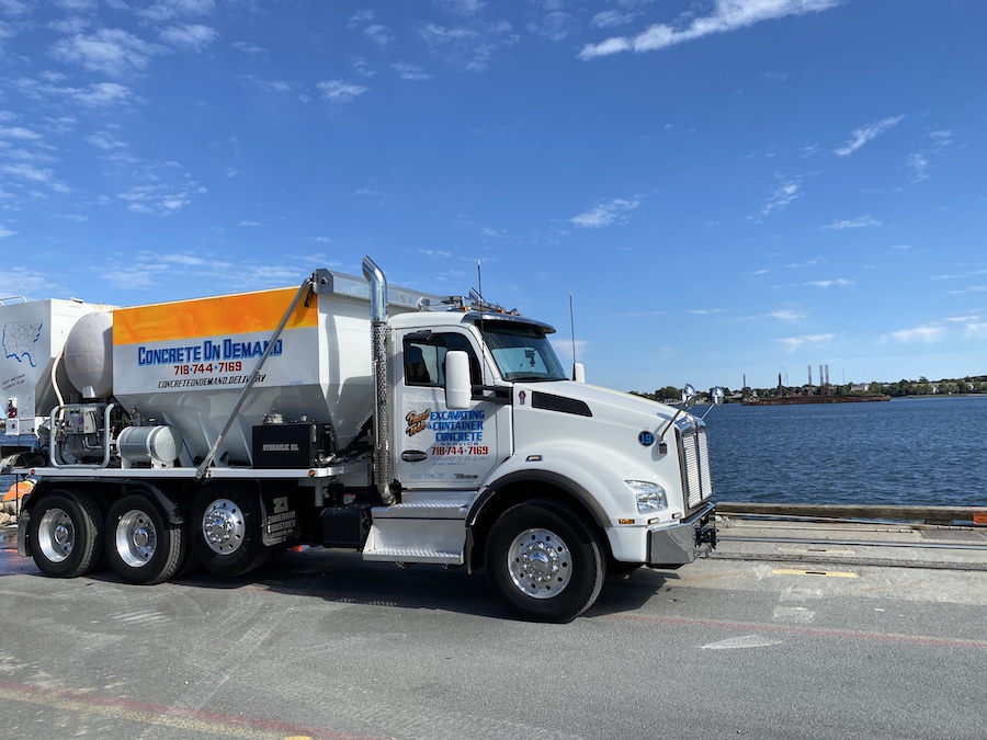 Side view of a Concrete on Demand volumetric mixer truck at the waterfront