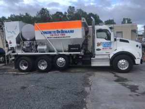 Side view of a Concrete on Demand on-site mixer truck