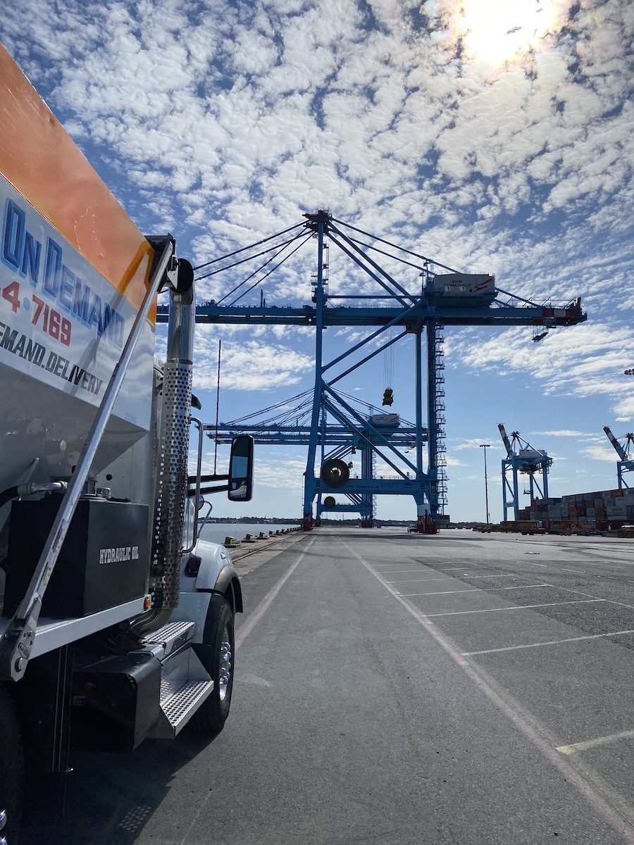 Rear of the mixer truck with the container terminal cranes in the background